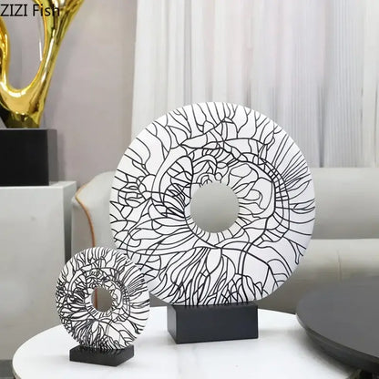 Modern white and black floral decorbites circle ornament featuring intricate black line art on a sleek black base