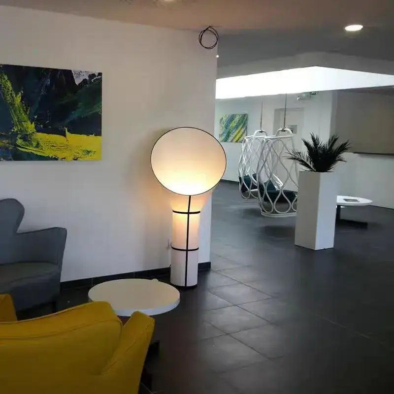 Modern white and black horn floor lamp with circular glowing shade and sleek accents for bedroom decorbites horn floor lamp