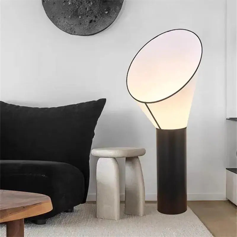 Modern white and black horn floor lamp with a sleek black base and softly glowing conical shade for bedroom decorbites floor lamp