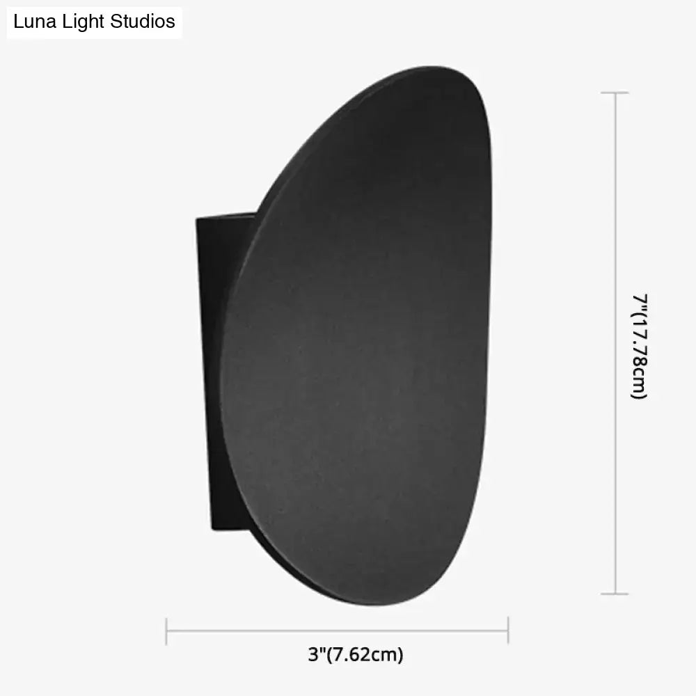 Black matte modern style wall sconce with oval curved face and rectangular mounting plate for bedroom LED spotlight