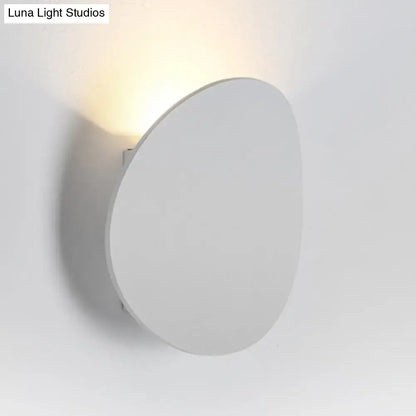 Modern white and black wall sconce in modern style emitting a warm soft glow for bedroom LED spotlight lighting