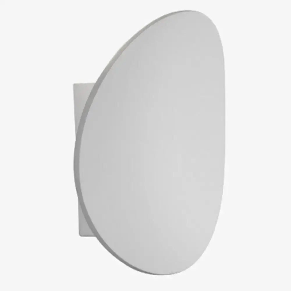 Modern white oval wall-mounted mirror with a sleek minimalist design paired with modern style white and black wall sconce