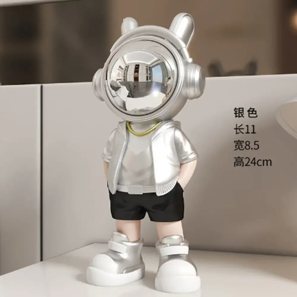 Modern white and blue astronaut resin sculpture featuring a silver figurine with reflective helmet and metallic jacket for decor