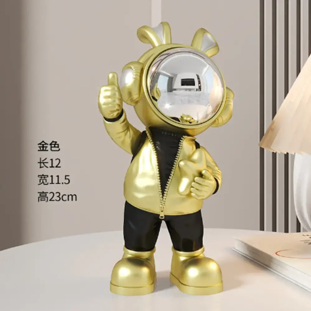 Modern white and blue astronaut resin sculpture with golden figurine in black zipper outfit giving thumbs-up for living room decor