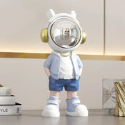 Modern white and blue astronaut resin sculpture with gold headphones and reflective visor for living room decor