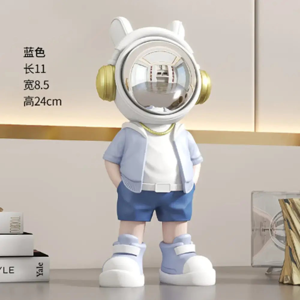 Modern white and blue astronaut resin sculpture featuring a blue figurine with white helmet gold earpieces and light blue shorts