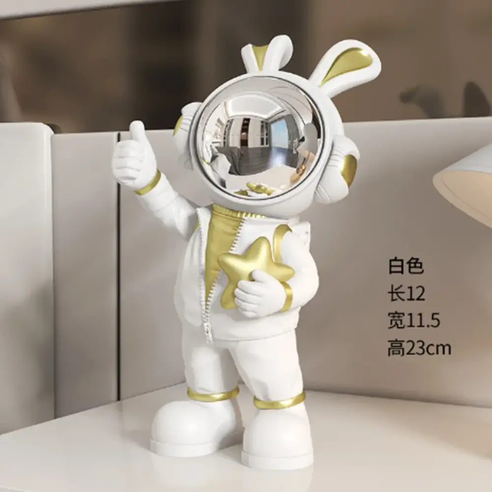 Modern white and blue astronaut resin sculpture featuring gold accents and a reflective helmet for living room decor