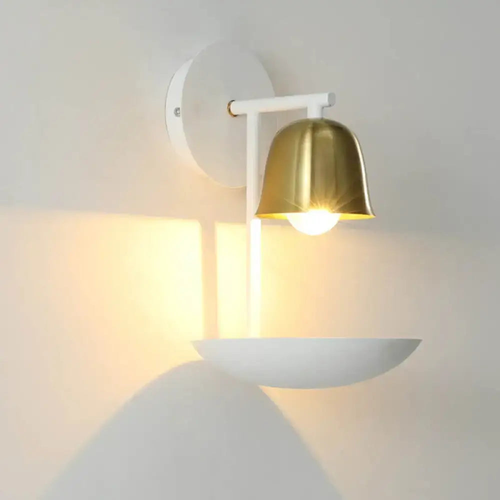 Modern white and brass bell metal sconce with polished brass shade and white metal arm for bedroom wall lighting