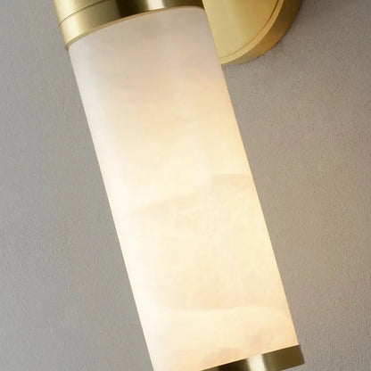 Modern white and brass pillar shaped sconce light with alabaster glass shade for bedside wall lamp use