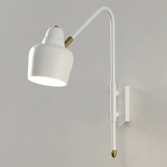 Modern white and brass v-shaped wall light with curved arm and brass accents ideal as a bedroom reading light type