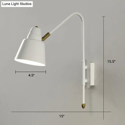 Modern white and brass v-shaped wall light with curved arm and brass accents ideal for bedroom reading light type