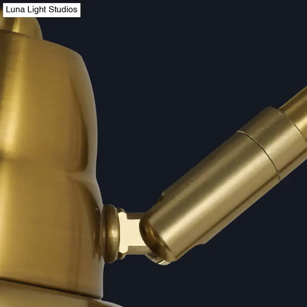 Modern white and brass v-shaped wall light with brass-finished adjustable desk lamp arm and sleek cylindrical design light type