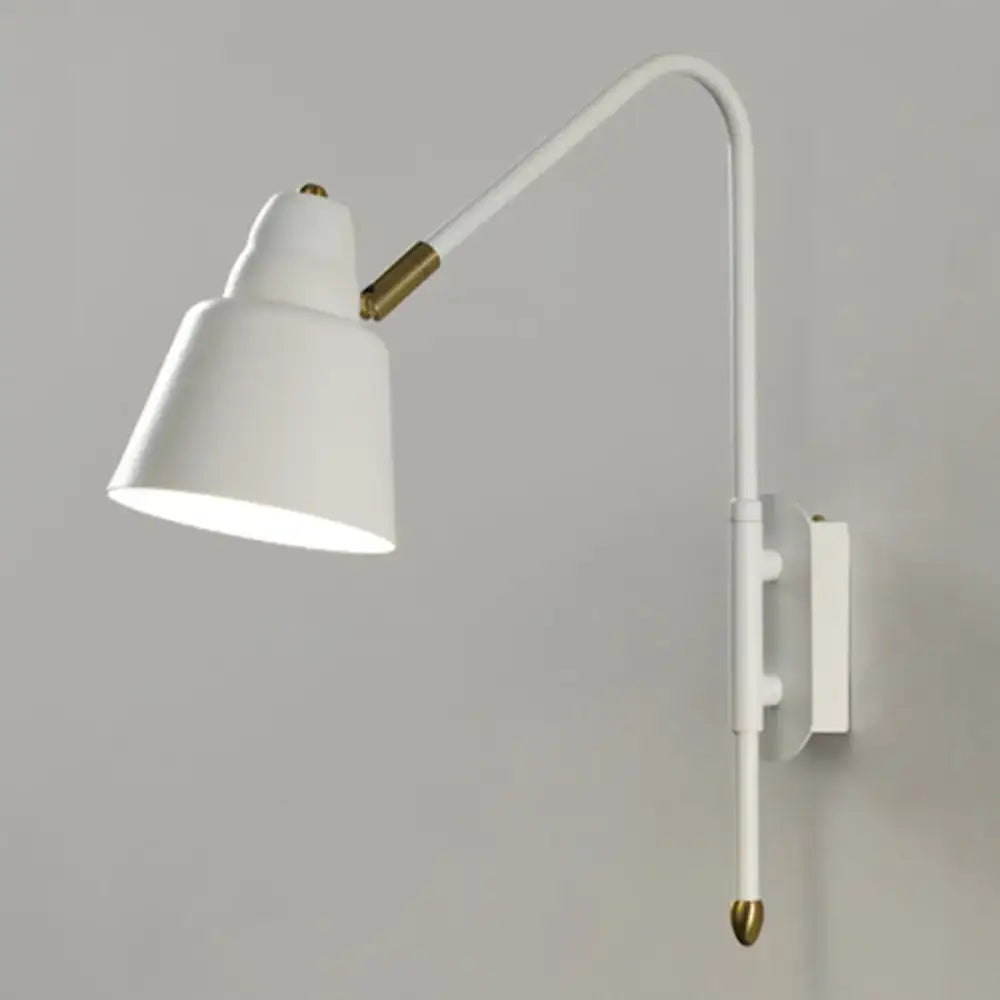 Modern white and brass v-shaped wall light with curved arm is a bedroom reading lamp light type