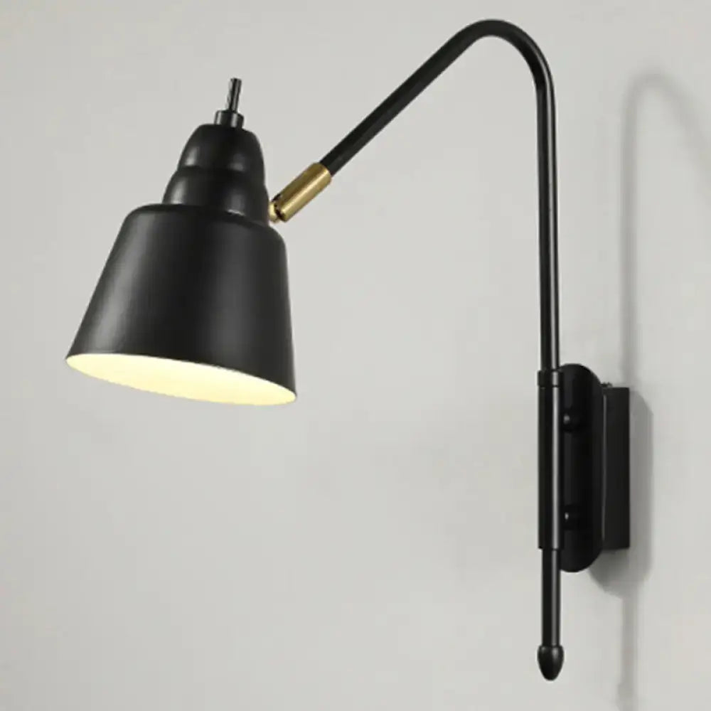 Black matte finished modern v-shaped wall light with brass joint and adjustable gooseneck arm for bedroom reading
