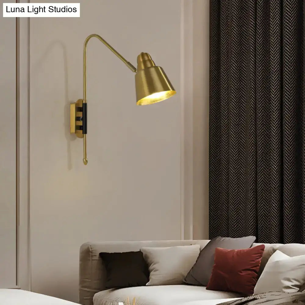 Modern white and brass v-shaped wall light with gold-toned brass articulated arm and conical shade for bedroom reading