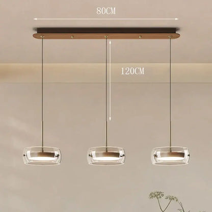 Modern white and clear glass pendant light with remote dimming featuring three glass bowls on dark wood ceiling bar