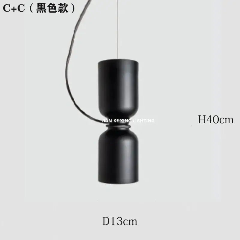 Black cylindrical pendant light with matte finish from decorbites designer iron chandelier for modern dining room decor