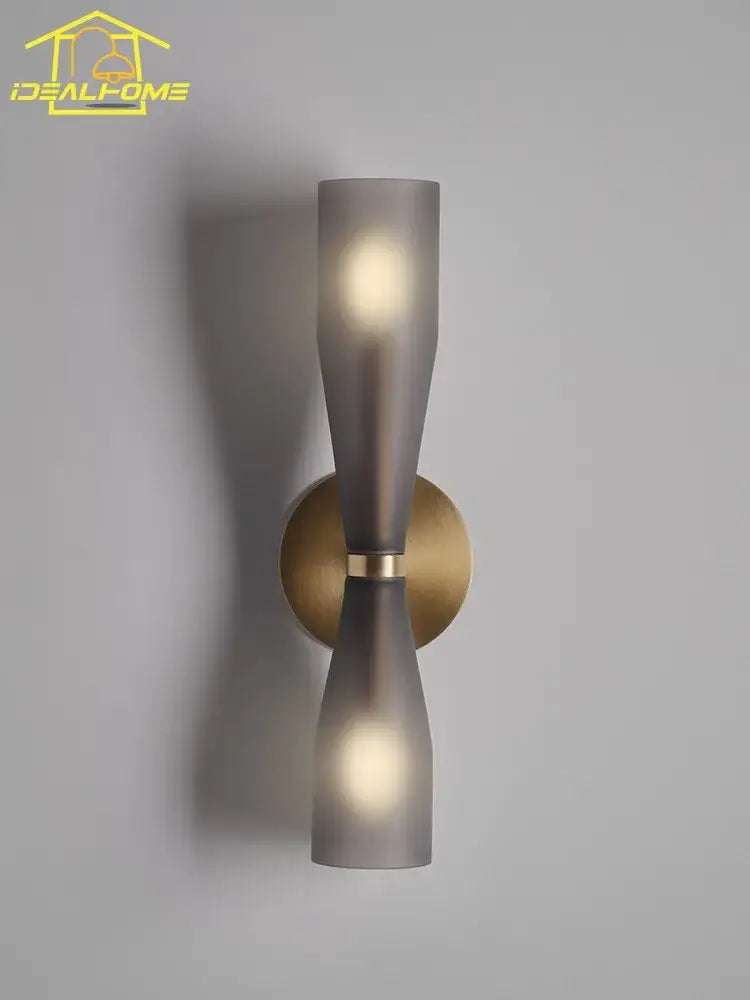 Modern wall lamp with two frosted gray glass shades and brass circular base for bedroom decorbites etcetera copper wall use