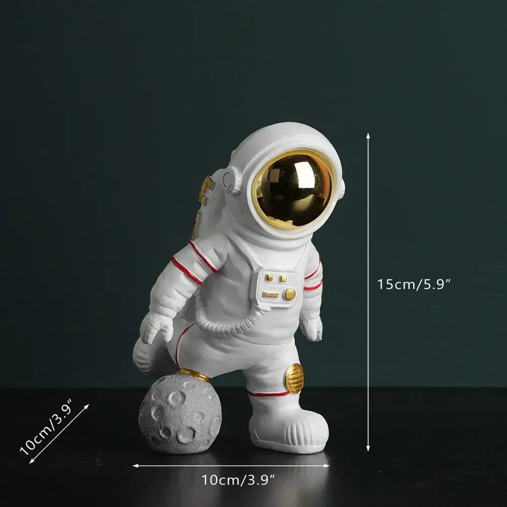 Modern white astronaut figurine with electroplated golden visor and accents standing on textured gray moon surface