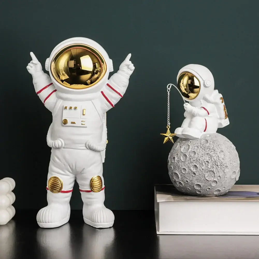 Modern white astronaut figurine with electroplated golden visor and red accents in a celebratory pose for living room decor