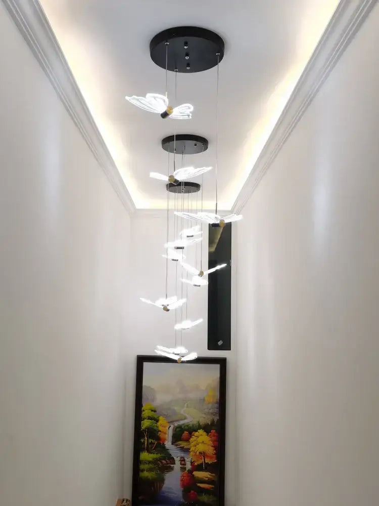 Modern white and gold butterfly chandelier featuring translucent white butterfly lights suspended from black fixtures decorbites butterfly chandelier