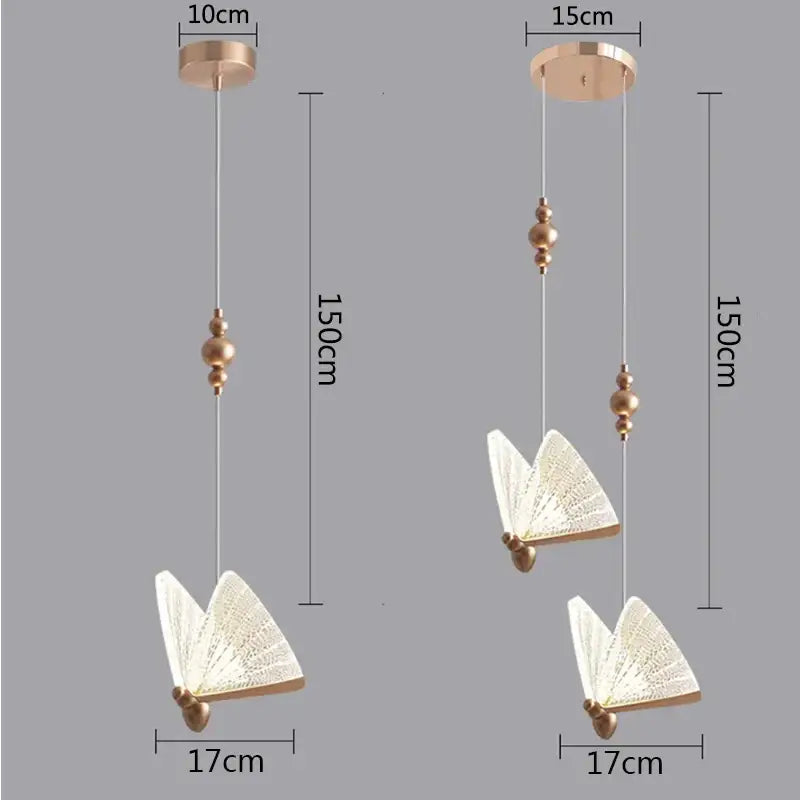 Modern white and gold decorbites butterfly pendant lights featuring gold-toned fan-like wings and spherical beads