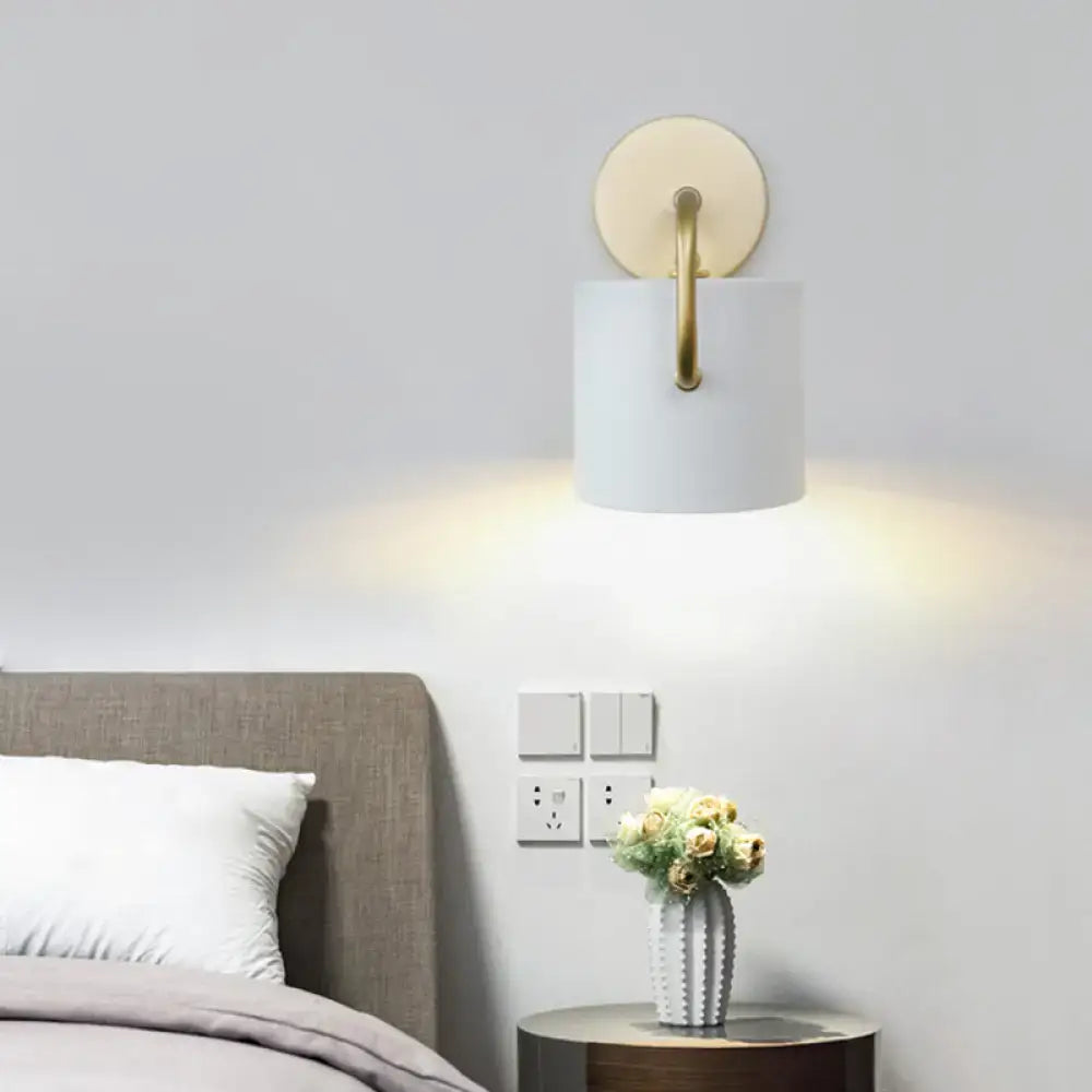 Modern white and gold cylinder wall lamp with a direct wired electric sconce light fixture for bedroom use