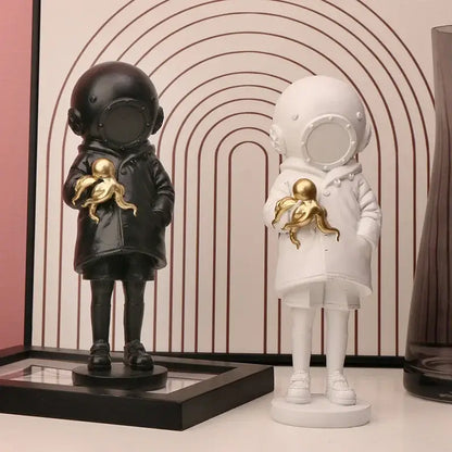 Modern white and gold deepsea diver sculpture featuring black and white astronaut figurines holding golden octopus decor
