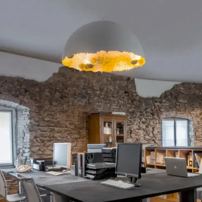 Modern pendant light with a matte white eggshell acrylic resin dome and illuminated textured gold interior for dining room
