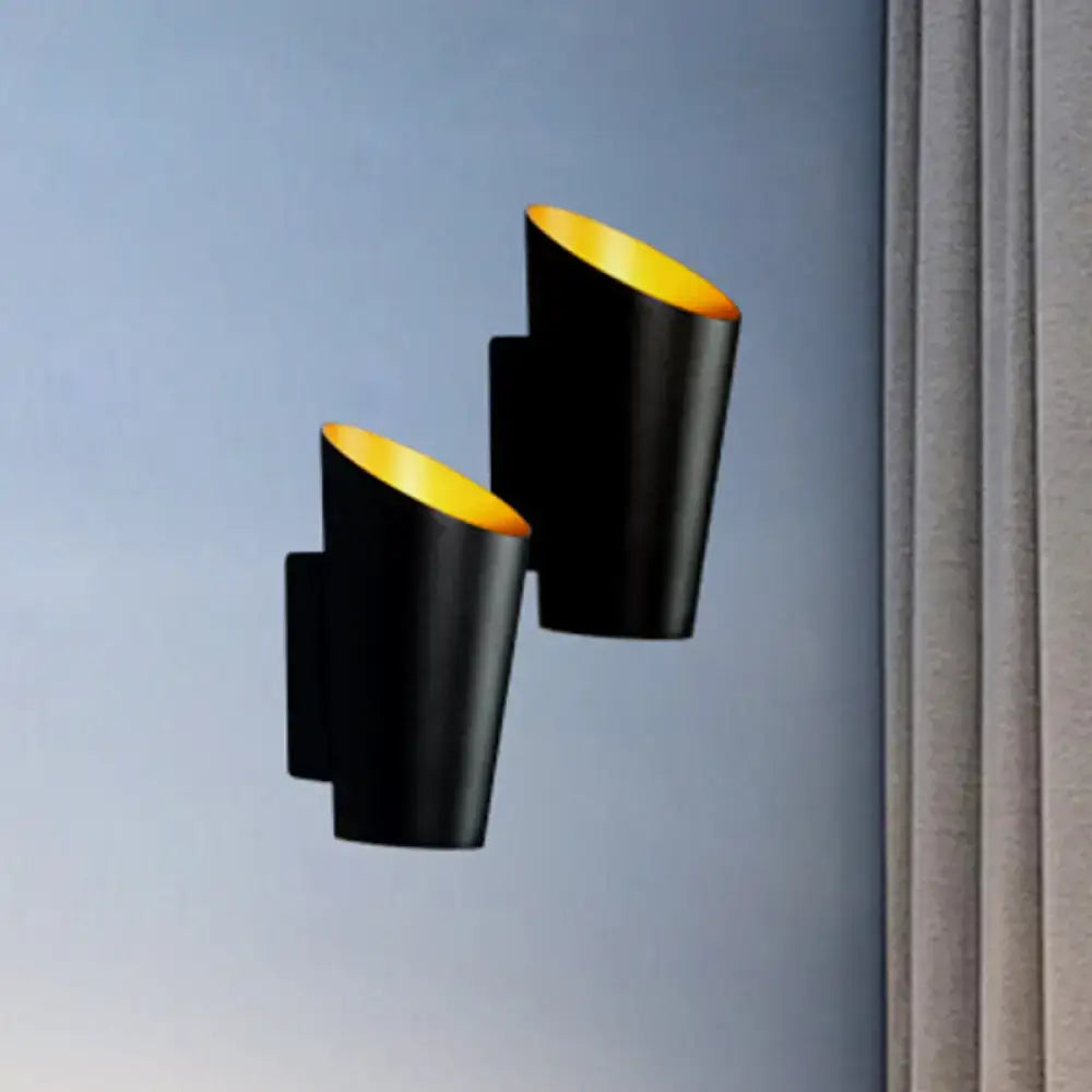 Modern white and gold led bedside sconce featuring black cylindrical wall light with gold-lined interior for bedroom use