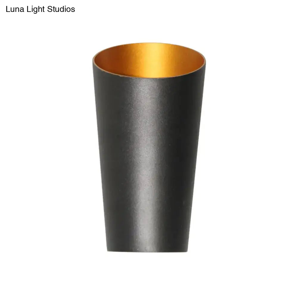 Modern led bedside sconce wall light featuring a black cylindrical cup with gold interior for bedroom illumination