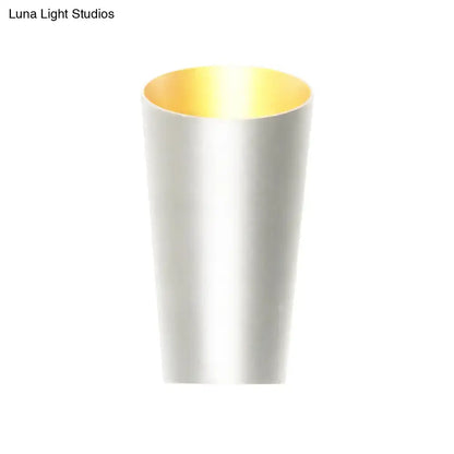 Modern led bedside sconce with a sleek cylindrical matte white exterior and reflective gold interior wall light