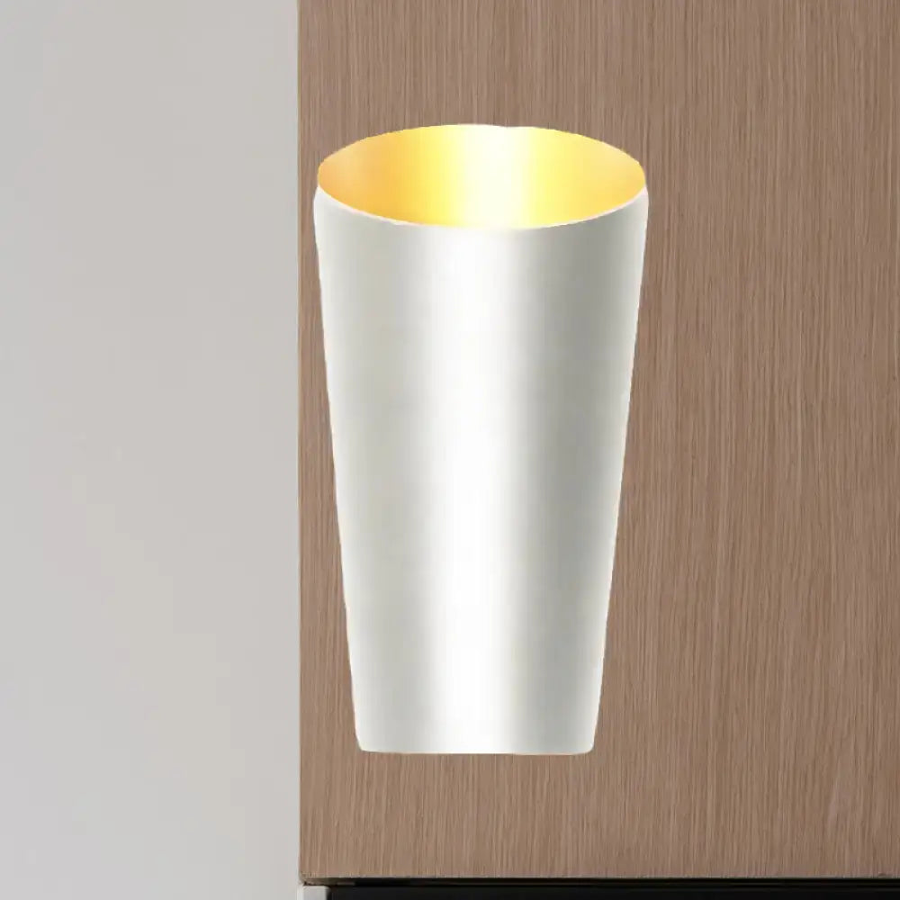 A modern led bedside sconce wall light with a sleek white cylindrical body and warm gold interior lining