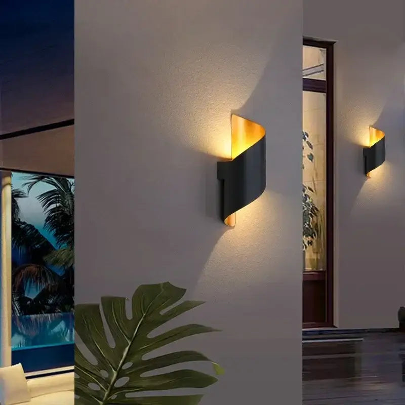 Modern black and gold wall lamp with a sleek curved design ideal as an outdoor wall lamp or patio sconce