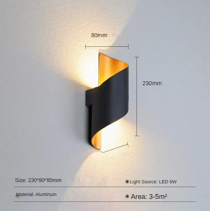 Modern black and gold aluminum wall lamp with a sleek twisted design suitable for outdoor wall and patio use