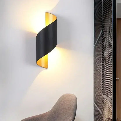 Black and gold twisted outdoor wall lamp with sleek modern design for patio use as a spiral outdoor wall sconce