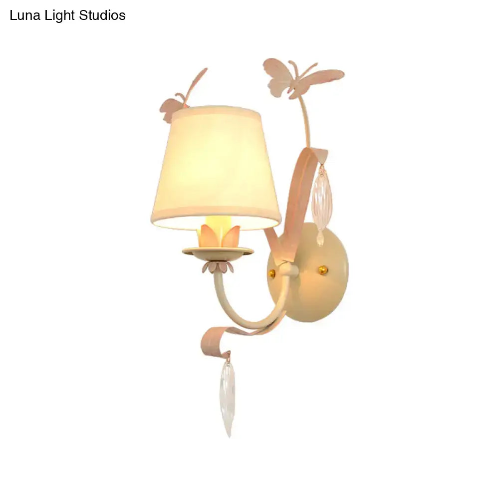 Pastel pink metal wall lamp with butterfly accents and crystal droplets for modern home décor in white finish