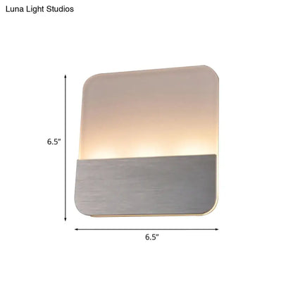 Modern white and silver led sconce light with brushed metallic base and warm glow for bedroom illumination