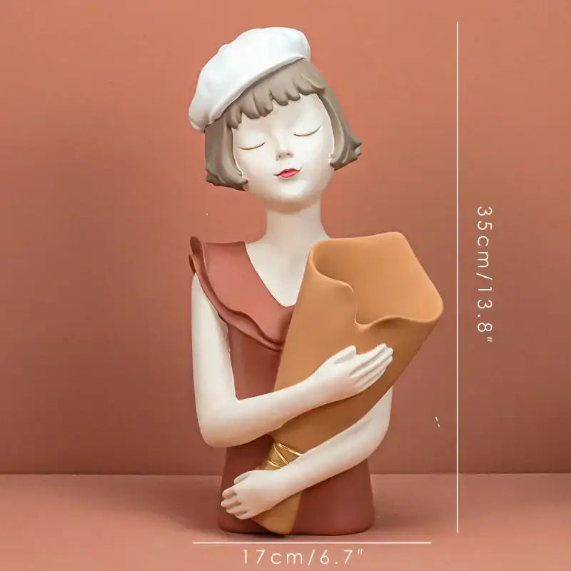 Modern white and tan balloon girl bust ceramic figurine in a terracotta dress holding an orange scroll for living room decor