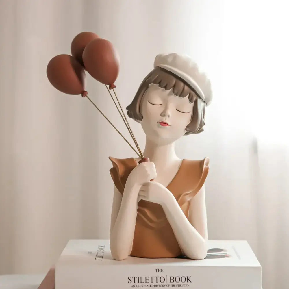 A ceramic balloon girl bust sculpture in white and tan featuring a girl bust vase with brown balloons for living room decor
