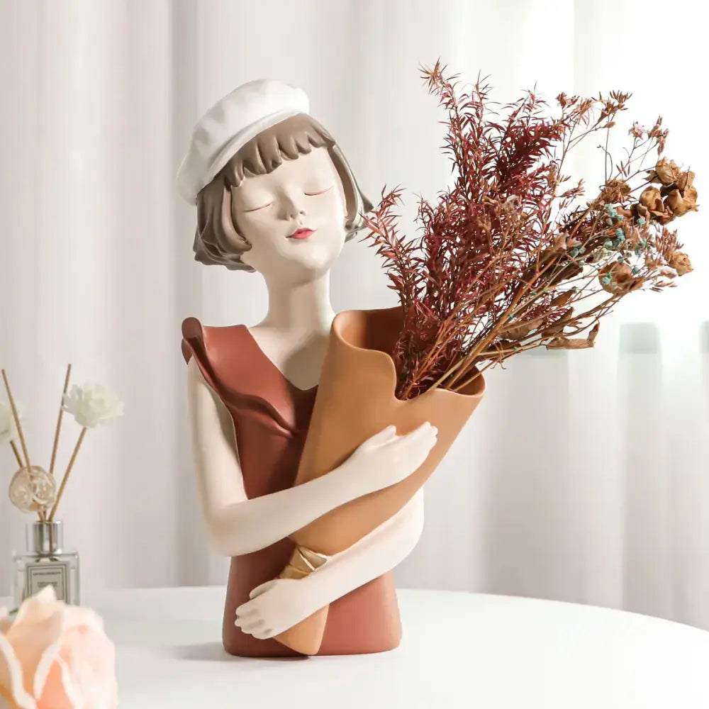 A ceramic balloon girl bust sculpture in white beret and rust dress holding dried flowers for living room decor