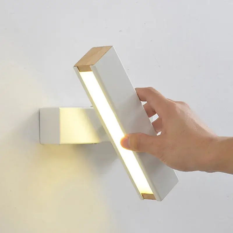 A modern white and wood decorbites adjustable wooden led wall lamp with sleek rectangular design for bedroom decor