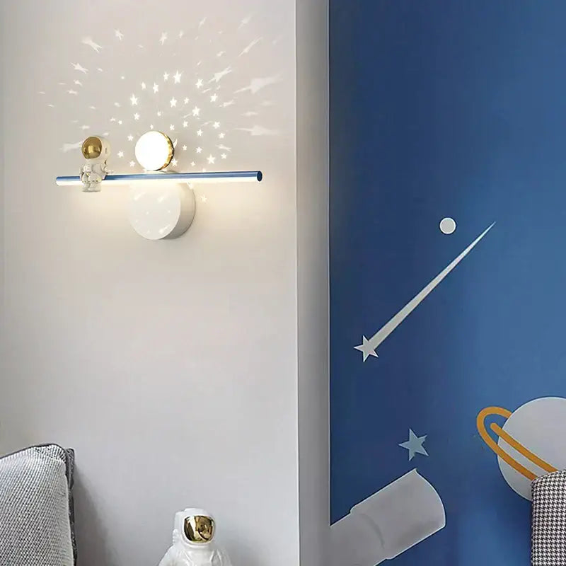 Modern white astronaut moon wall lamp with blue metallic bar and golden sphere projecting starry patterns for bedroom decorbites astronaut moon