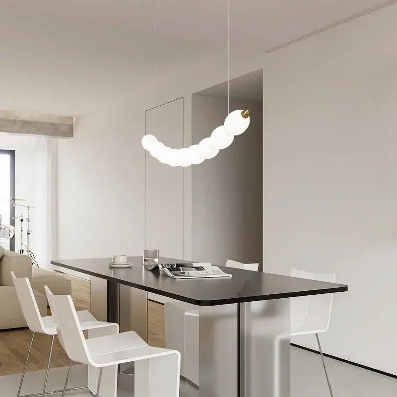 Modern white bead nordic chandelier pendant light with curved white design, spherical bulbs, and gold-toned fixture for dining room