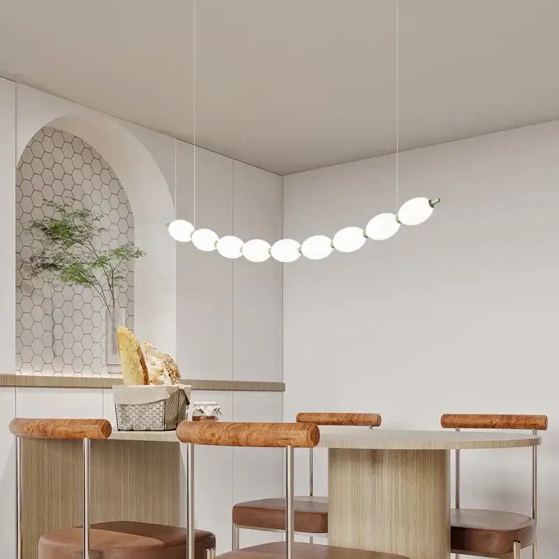 Modern white bead nordic chandelier with spherical bulbs arranged in an elegant curved line for dining room use