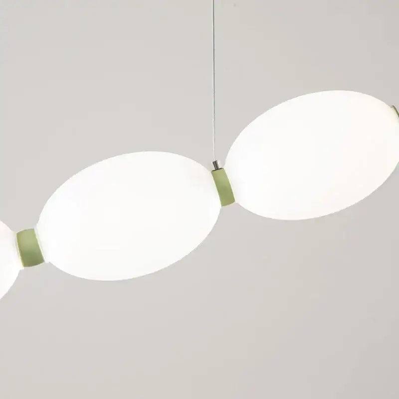 Modern white bead nordic chandelier with two oval frosted glass shades and matte sage green metal joints for dining room