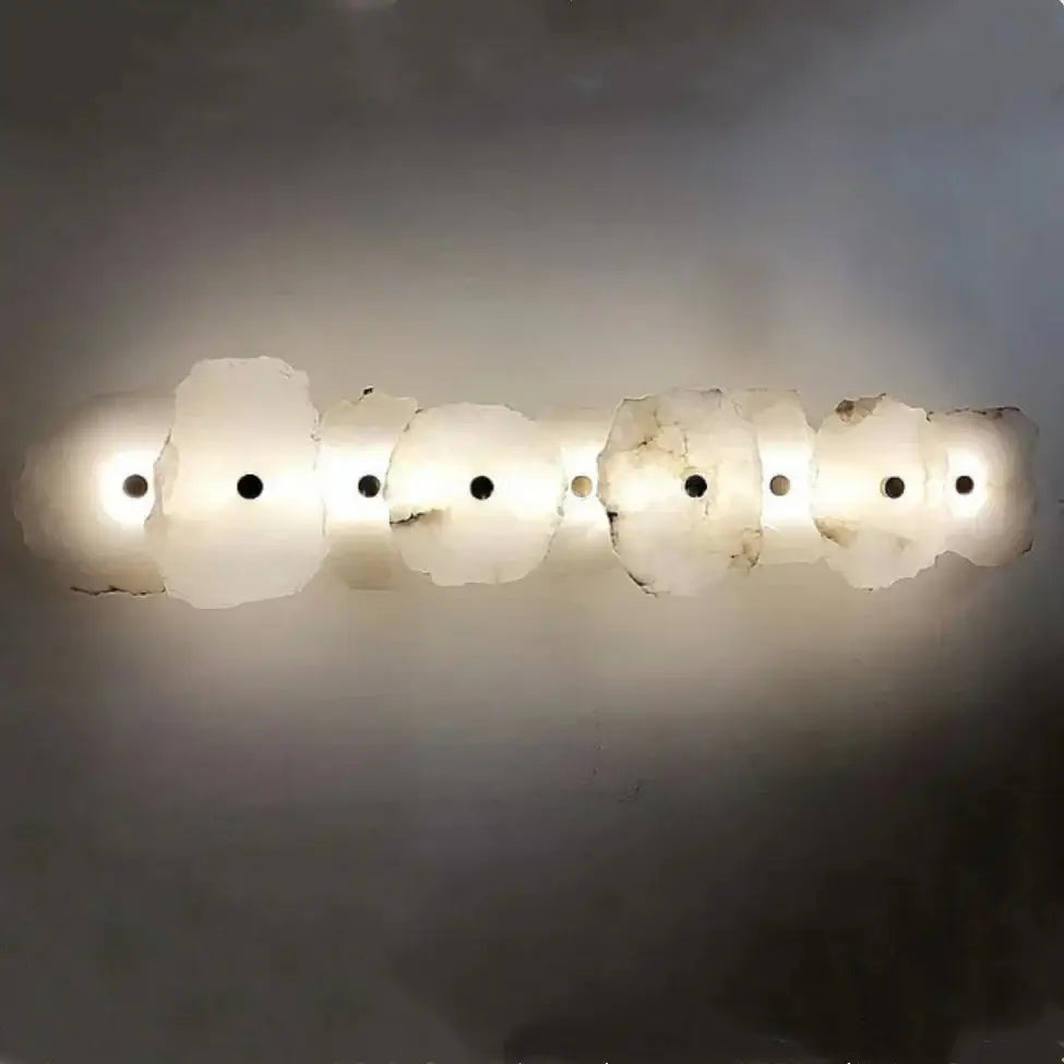 Modern white and beige stone brass wall lamp with six opalite discs and black accents for bedroom decorbites brass wall lamp