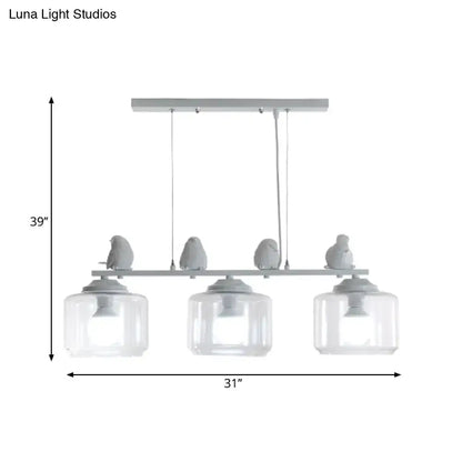 Modern gray bird-themed island lighting fixture with three clear glass shades and sleek metal frame for dining room