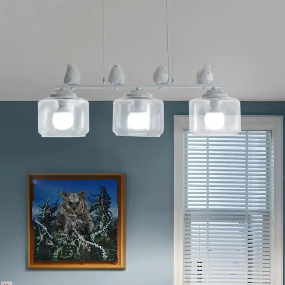 White bird-themed pendant island lighting fixture with clear glass shades and modern design for dining room use