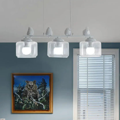 White bird-themed pendant island lighting fixture with clear glass shades and modern design for dining room use